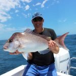 Guest with a Snapper fish during fishing charter in Noosa